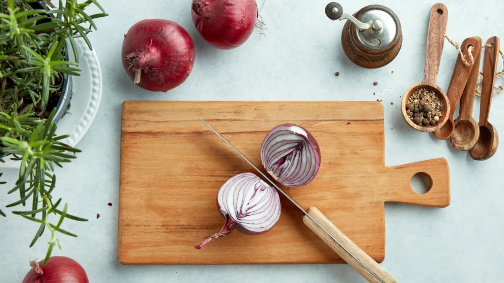 cutting-onions-on-a-wooden-board-jpg.webp.webp