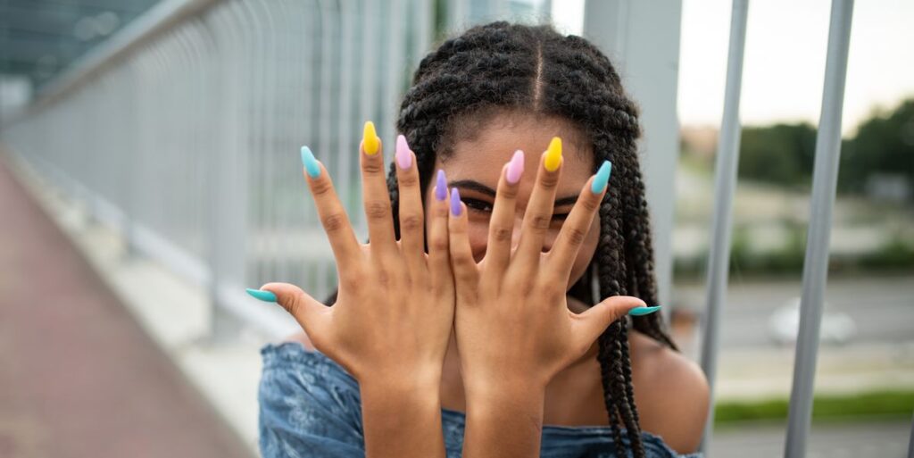 model-on-city-bridge-posing-with-colorful-nails-royalty-free-image-1745938006.pjpeg_.jpeg
