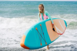 young-blonde-woman-holding-stand-up-paddle-board-2025-03-09-01-39-55-utc-1-jpg.webp.webp